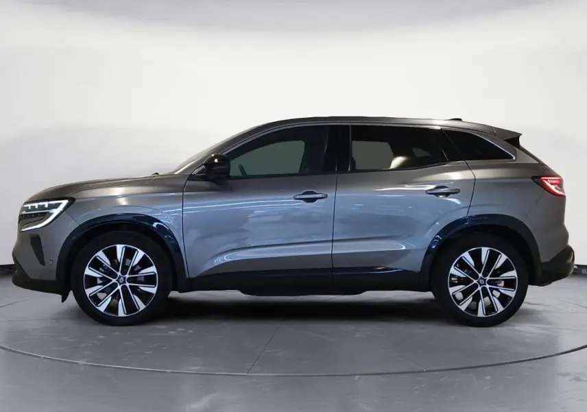 Renault Austral E-Tech hybride 2024 gris métallisé, vue profil côté gauche avec jantes alliage 19 pouces.
