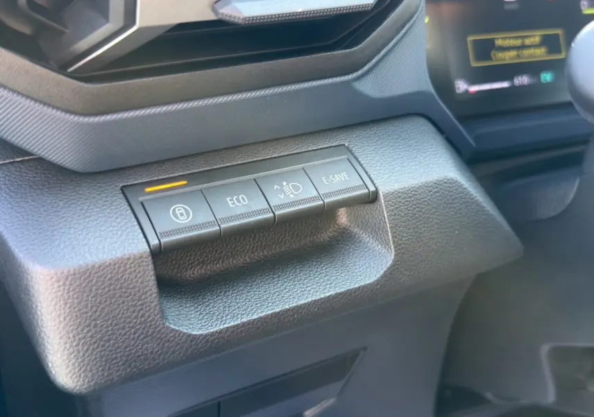 Gros plan sur les boutons de commande gris foncé du tableau de bord du Dacia Duster Expression Hybrid 140, côté conducteur.