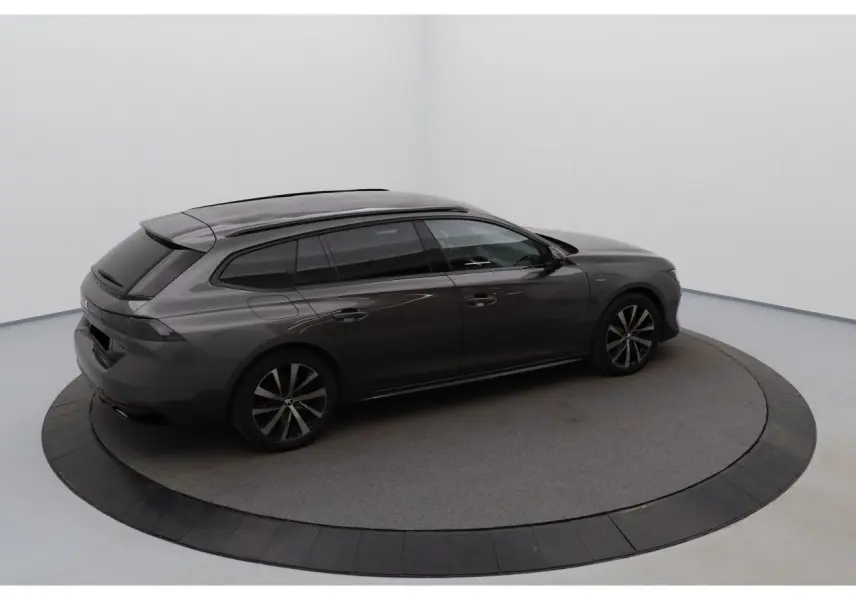 Peugeot 508 SW gris Platinium en 3/4 arrière droit, soulignant ses lignes fluides et vitres teintées.