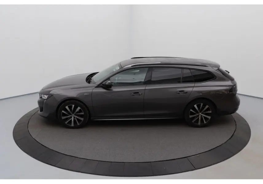 Peugeot 508 SW gris Platinium vue de profil côté gauche, jantes alliage bi-ton et barres de toit noires brillantes.