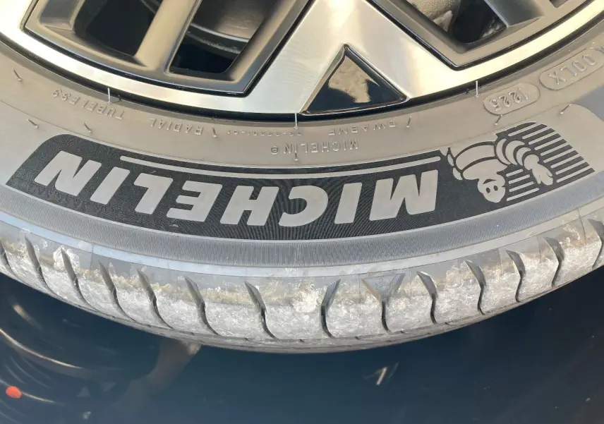 Gros plan sur la jante alliage diamantée 18 pouces et pneu Michelin du Citroën C4 noir Perla facelift hybrid 2025.