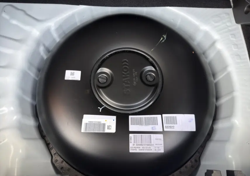 Gros plan sur le réservoir GPL noir rond dans le coffre blanc de la Dacia Sandero Stepway Expression ECO-G 2022.