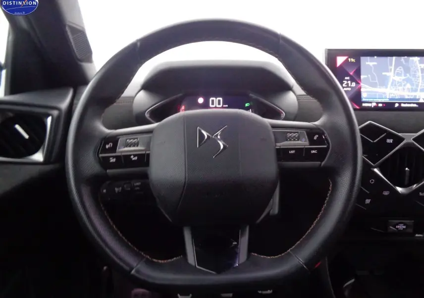Vue rapprochée du volant en cuir noir du DS3 Crossback 2021 avec tableau de bord digital et écran tactile GPS.