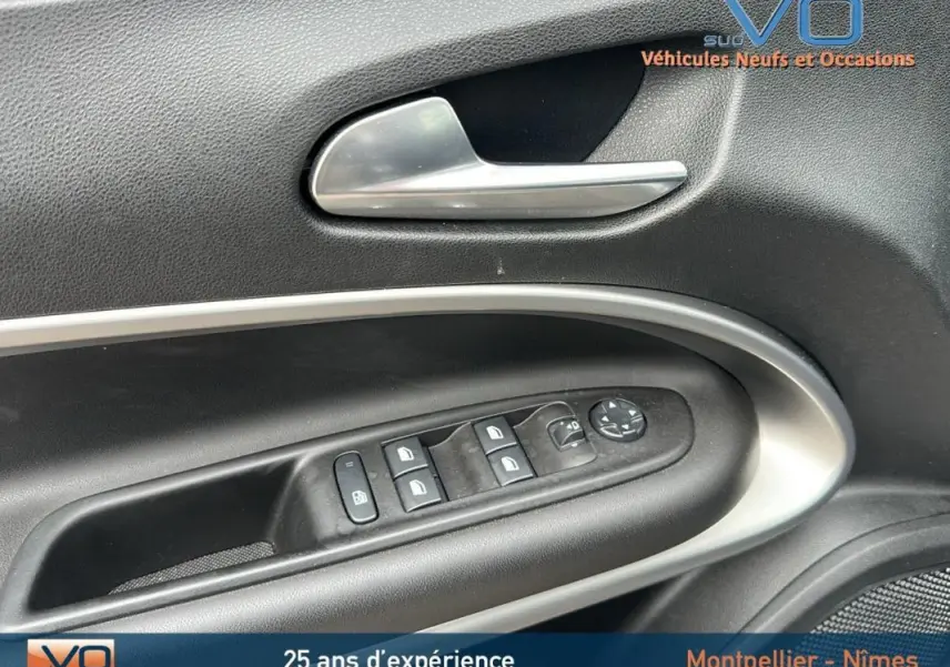 Gros plan sur la commande des vitres et rétroviseurs côté conducteur du Jeep Avenger gris foncé 2024 Altitude.