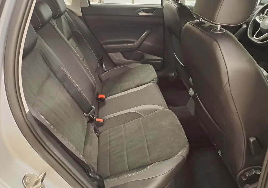 Vue intérieure côté gauche des sièges arrière en tissu noir et gris d'une Volkswagen Polo 2025 reflet d'argent.