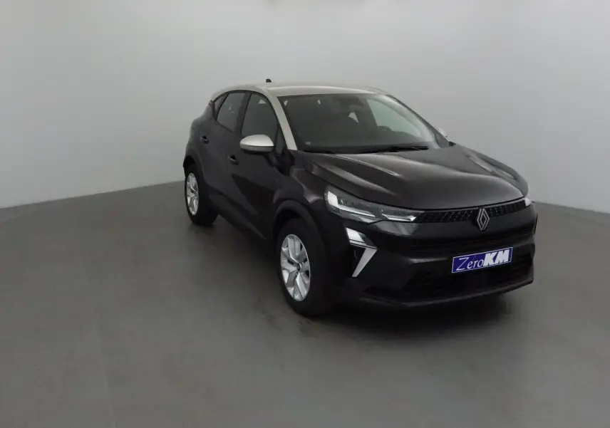 Renault Captur 2025 noir et gris perle en 3/4 avant droit, avec signature lumineuse LED et calandre noire distinctive.