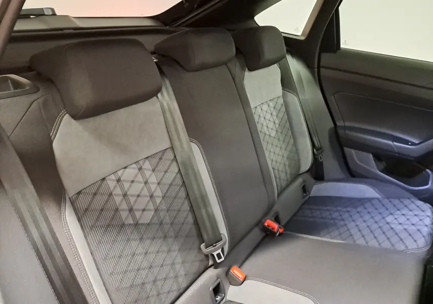 Vue intérieure de la banquette arrière du Volkswagen Taigo 2025, tissu noir et gris avec motifs géométriques.
