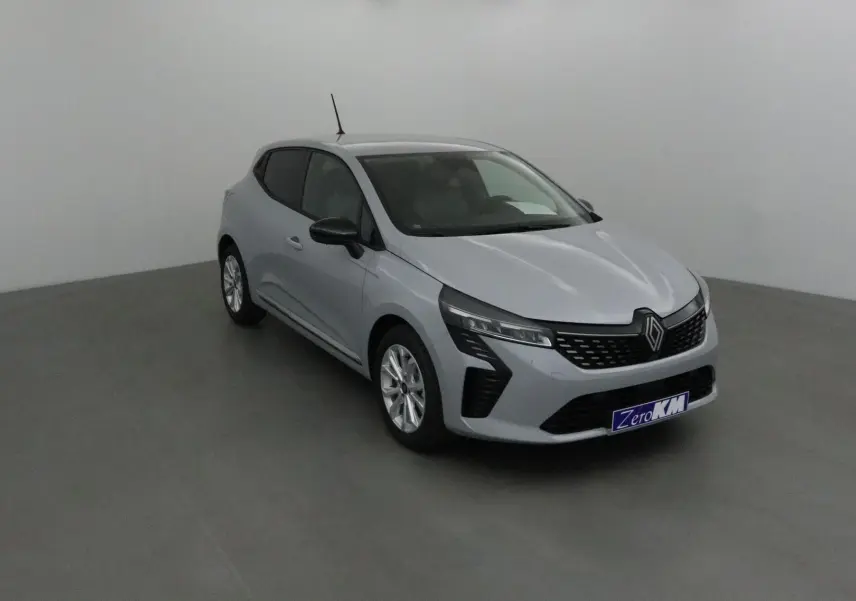 Renault Clio V gris Rafale vue 3/4 avant droit, avec calandre noire et jantes alliage 16 pouces visibles.