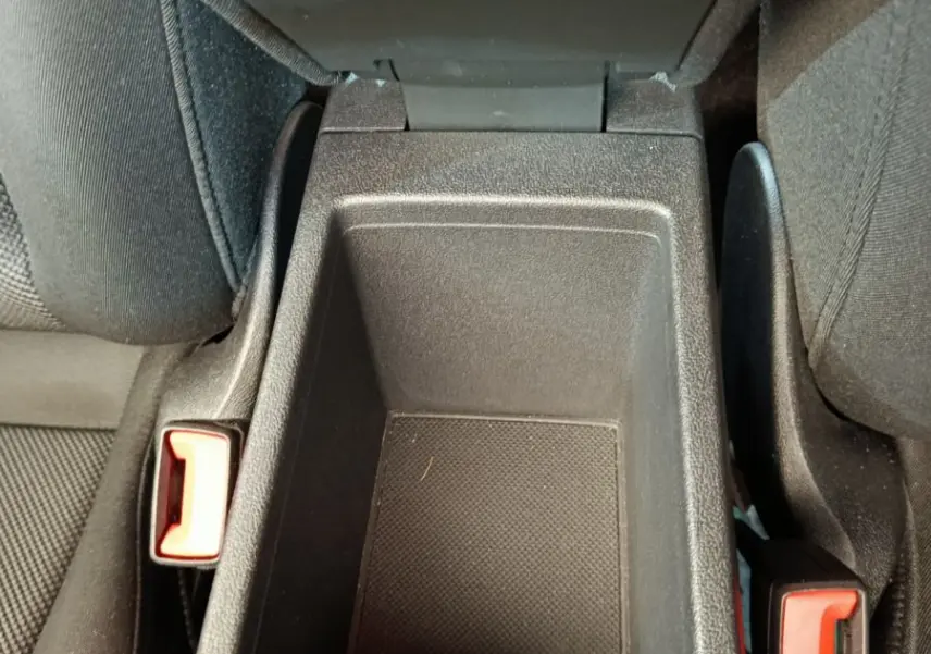 Vue plongeante sur le rangement central noir entre les sièges avant de l'Audi A3 30 TFSI MHEV 2022.