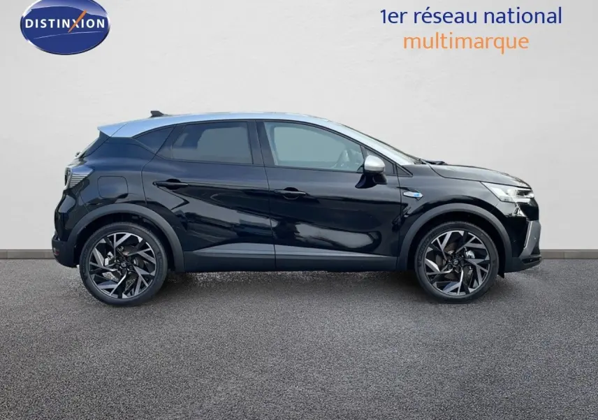 Profil côté gauche du Renault Captur E-Tech hybride 2025 noir étoile avec toit gris et jantes noires bicolores.