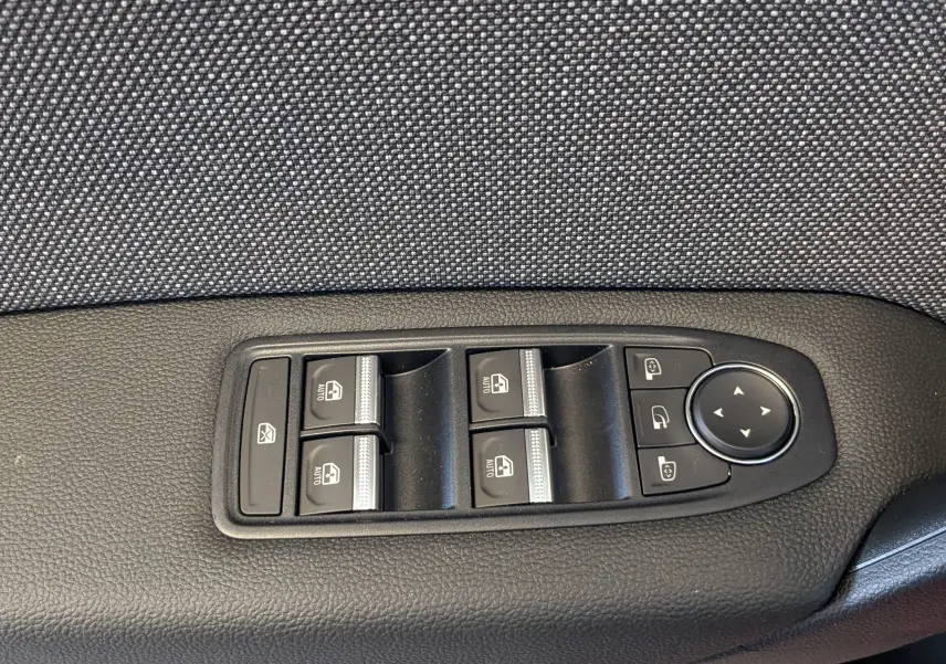 Panneau de commandes des vitres et rétroviseurs côté conducteur du Renault Captur E-Tech 2025, finition tissu gris.
