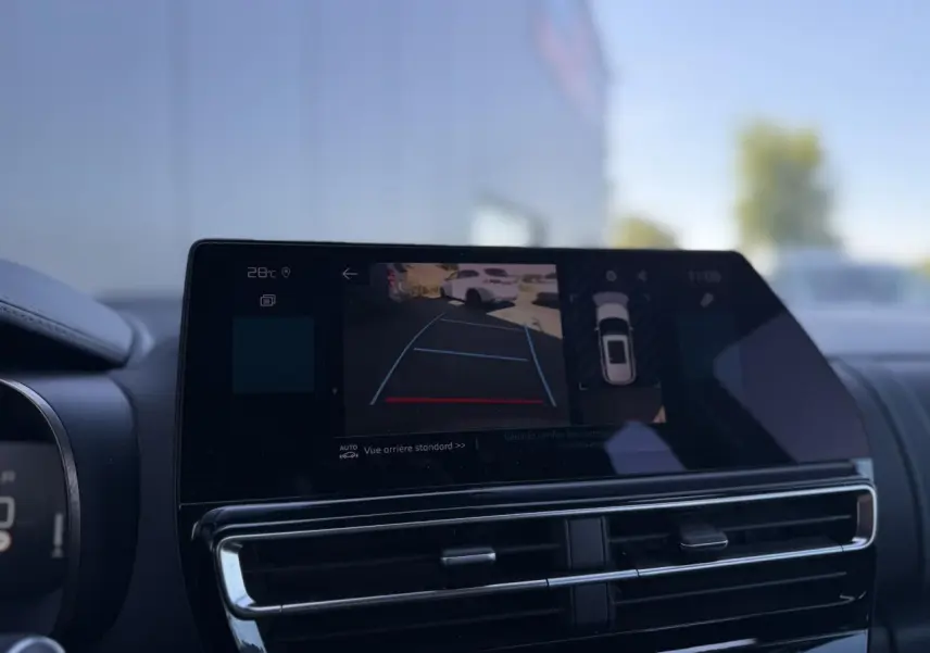 Écran tactile intérieur montrant la caméra de recul du Citroën C5 Aircross Hybrid gris Platinium, vue avant du tableau de bord.