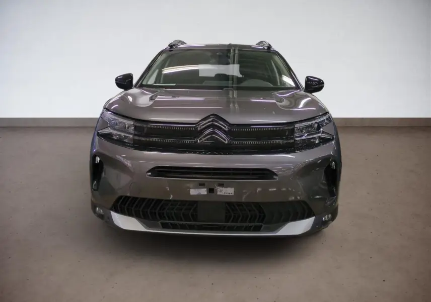 Vue de face du Citroën C5 Aircross Hybrid gris Platinium avec calandre noire et feux LED fins.