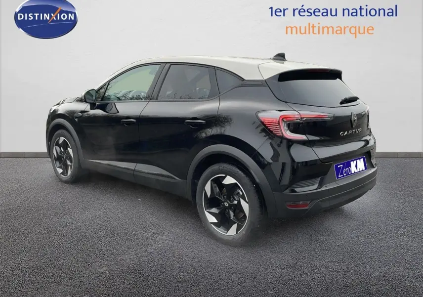 Vue 3/4 arrière droite du Renault Captur noir étoile métal avec toit beige, mettant en valeur ses feux LED et jantes biton.