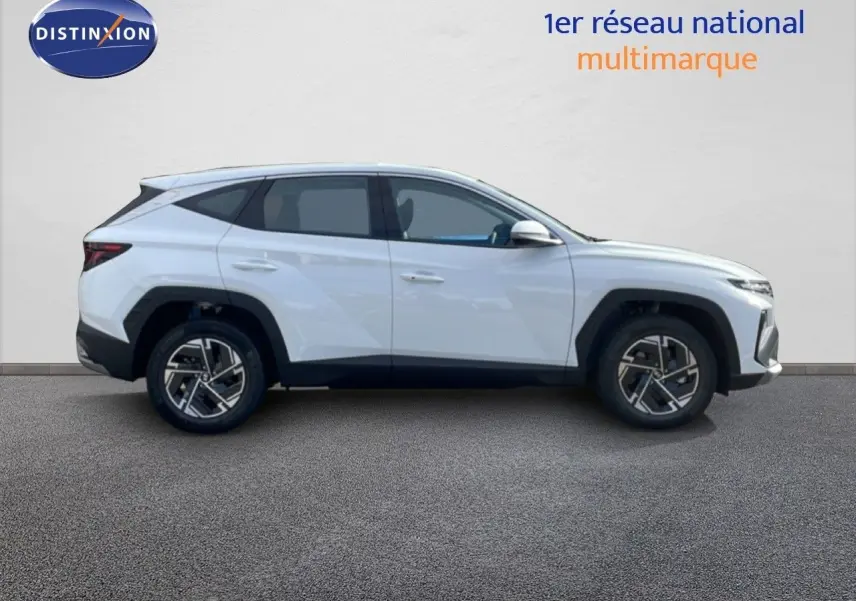 Profil droit du Hyundai Tucson blanc Atlas 2026, avec jantes alliage et lignes anguleuses modernes.