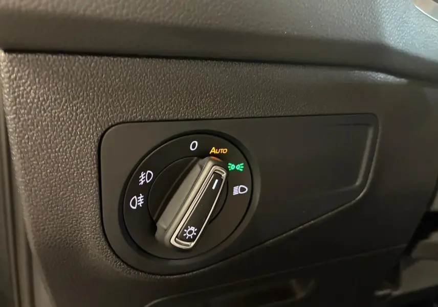 Gros plan sur le bouton de commande des phares du Volkswagen Tiguan 2020, avec éclairage automatique activé.