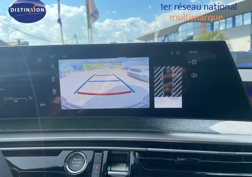 Vue intérieure du tableau de bord du Peugeot 5008 Hybrid 2025 avec écran affichant la caméra de recul en marche.