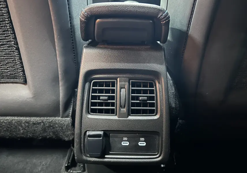Vue rapprochée des aérateurs arrière et ports USB du Renault Captur II Ph.2 E-Tech, intérieur noir.