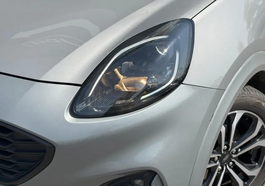 Gros plan sur le phare avant droit et la jante alliage 17 pouces du Ford Puma Gris Solar 2020 finition ST Line.