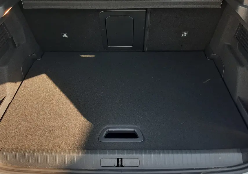 Vue plongeante sur le coffre noir d’un Citroën C4 blanc Okenite 2025, version hybride avec ouverture arrière visible.