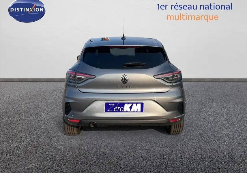 Vue arrière d’une Renault Clio gris schiste métal 2025 avec feux LED et plaque Zero KM visible.