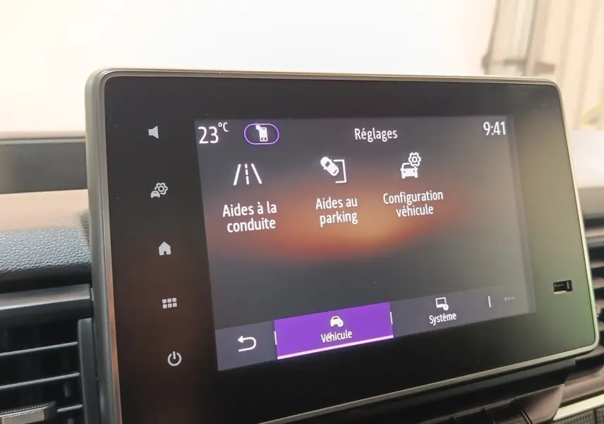 Écran tactile intérieur du Renault Trafic Fourgon 2023 affichant les réglages d’aides à la conduite et au parking.