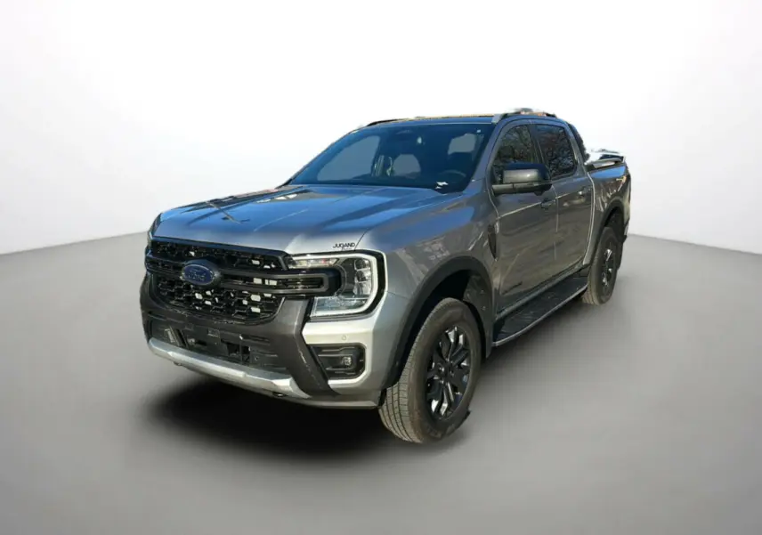 Ford Ranger 2.0 205 Wildtrak Plus gris iconic en 3/4 avant droit avec jantes alu noires et rideau coulissant électrique.