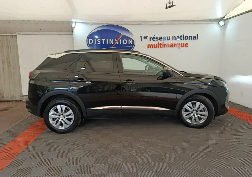 Profil côté gauche d’un Peugeot 3008 noir 2022, version BlueHDi 130 Style, dans un showroom avec sol gris et bandes rouges.