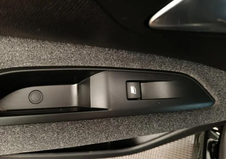 Détail de la commande de lève-vitre sur la porte côté conducteur du Peugeot 3008 noir 2022.
