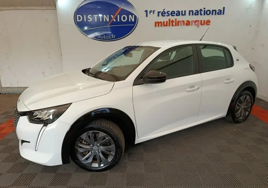 Peugeot 208 électrique blanche vue de 3/4 avant droit, avec rétroviseurs noirs et jantes gris foncé.