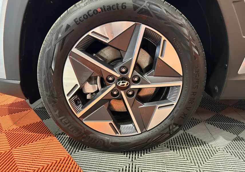 Gros plan sur la jante 18 pouces bi-ton du Hyundai Tucson 2025 Shimmering Silver, avec pneu Continental EcoContact 6.