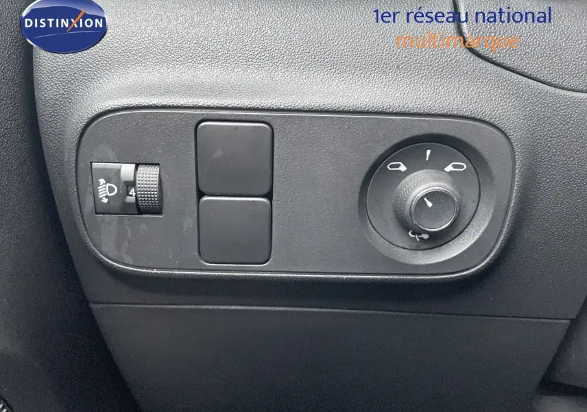 Gros plan sur les commandes de réglage des rétroviseurs et des phares d'une Citroën C3 gris acier toit noir, côté gauche.