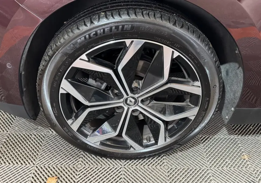 Gros plan sur la roue avant droite rouge du Renault Scenic Intens 2021 avec jante alliage noir et argentée.