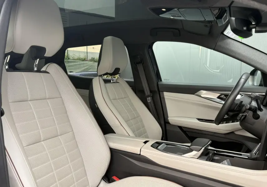 Intérieur côté conducteur du Renault Espace 2023, sièges cuir gris sable clair et toit panoramique visible