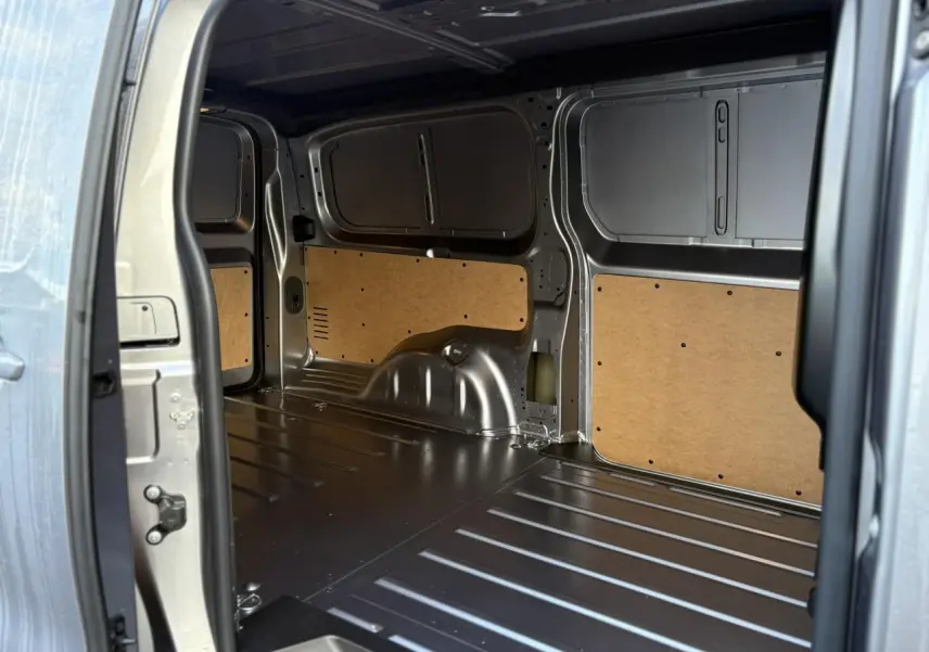 Intérieur de la zone de chargement du Citroën Jumpy XL gris Artense, vue depuis la porte latérale ouverte.