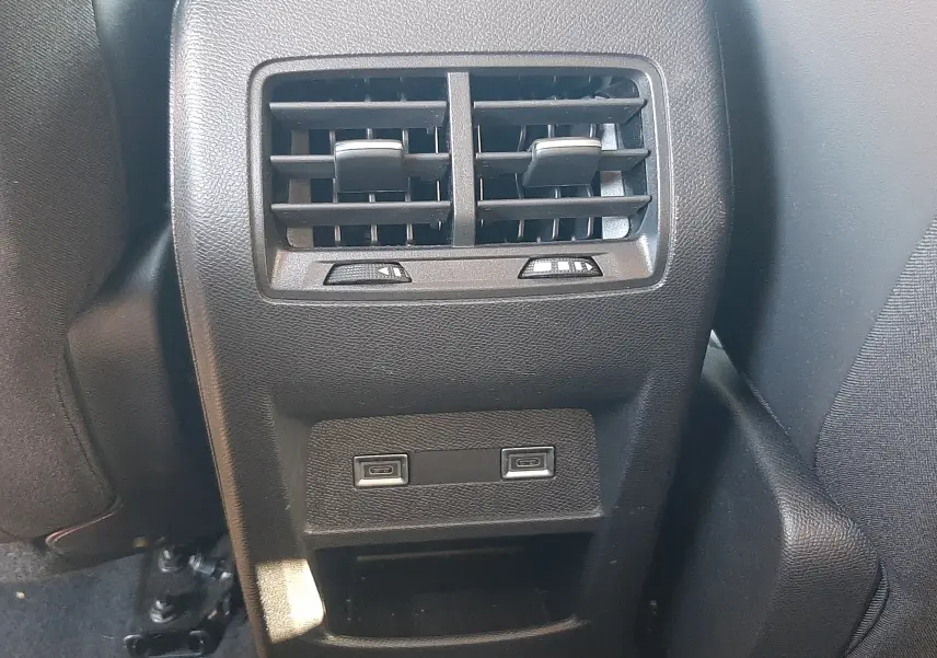 Vue rapprochée des aérateurs arrière et des ports USB du Peugeot 308 SW Hybrid 145ch finition Allure gris selenium metal.