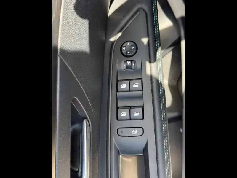 Vue rapprochée des commandes de lève-vitres et rétroviseurs sur la porte côté conducteur du Peugeot 3008 noir Perla Nera 2024.