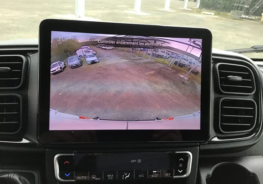 Écran central affichant la caméra de recul du Peugeot Boxer Fourgon blanc, vue arrière avec parking en arrière-plan.