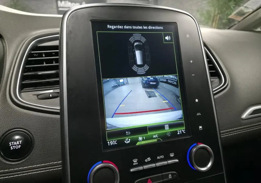 Écran tactile central du Renault Scénic blanc 2017 montrant la caméra de recul et les commandes de climatisation.