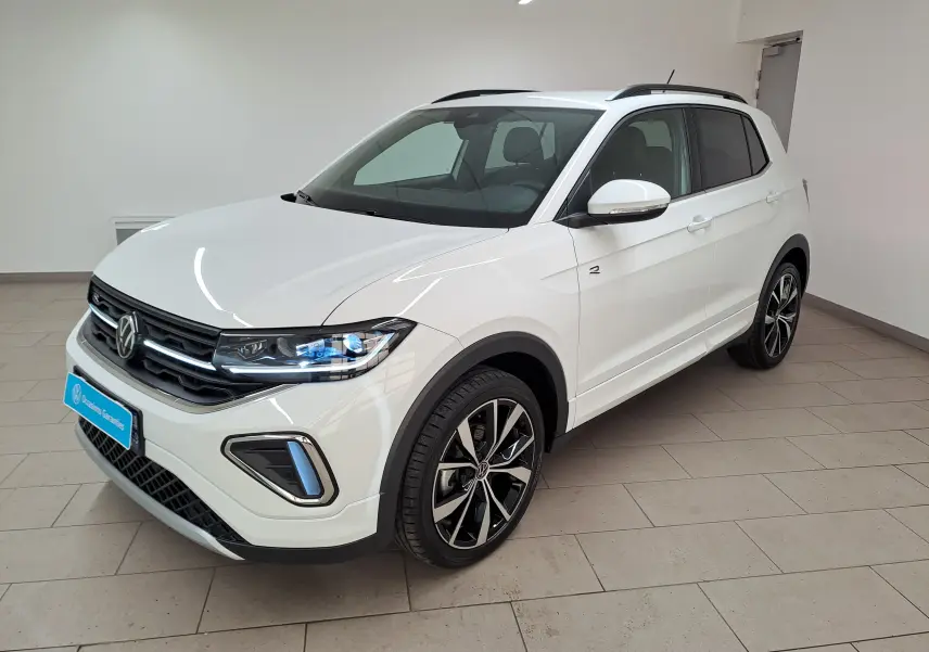 Vue de profil côté gauche du Volkswagen T-Cross blanc pur 2025 R-Line avec jantes alliage noires et toit noir.