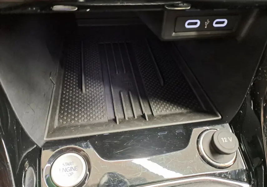 Détail de la console centrale du Volkswagen T-Cross blanc 2025, avec bouton start/stop, prise 12V et ports USB visibles.