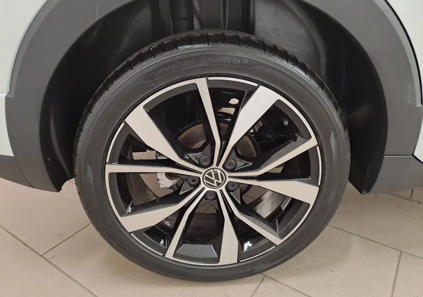 Volkswagen T-Cross blanc pur en vue 3/4 arrière droit, avec feux arrière LED et jantes alliage R-Line.
