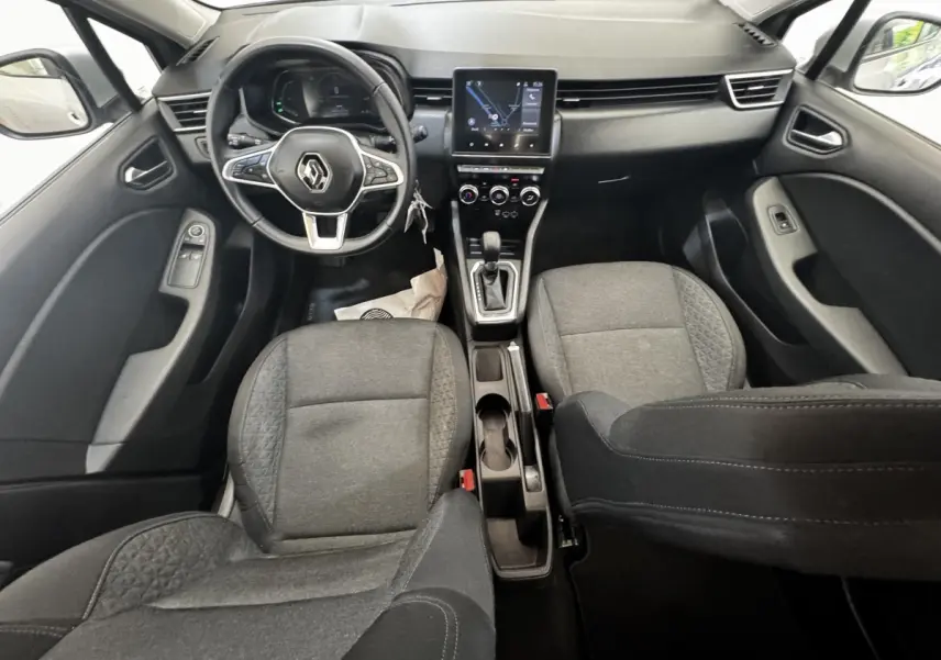 Vue intérieure avant de la Renault Clio Business E-TECH 140 gris clair, avec volant multifonctions et écran tactile central.