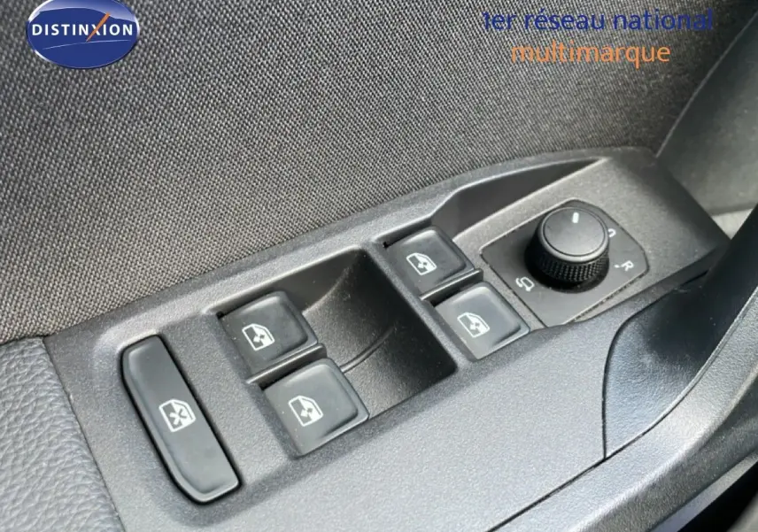 Gros plan sur les commandes des vitres électriques et réglage des rétroviseurs côté conducteur d’une SEAT Ibiza bleu Fjord.