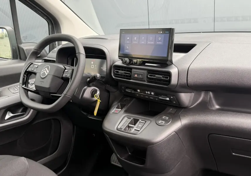Vue intérieure côté conducteur du tableau de bord noir avec écran tactile et volant multifonctions Citroën Berlingo Multispace.