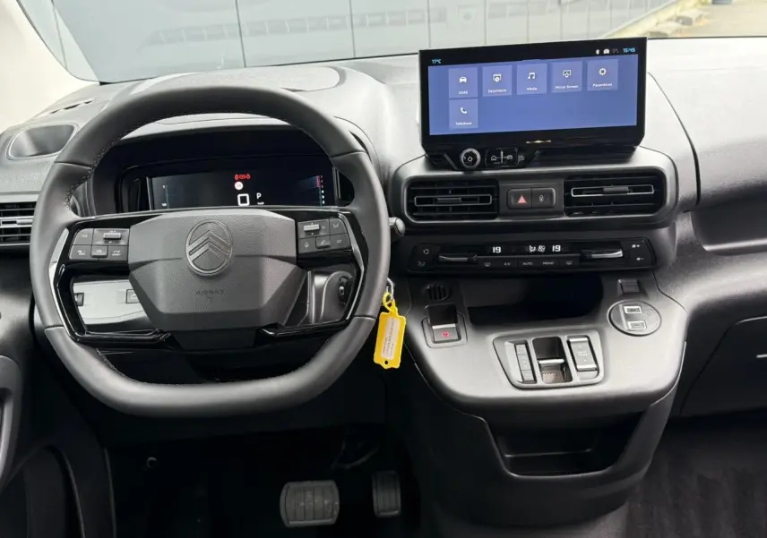 Vue intérieure frontale du tableau de bord et volant noir du Citroën Berlingo Multispace 2026 avec écran tactile et commandes intégrées.