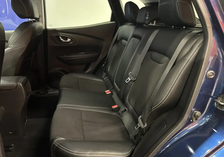 Vue intérieure côté gauche des sièges arrière noirs en tissu et cuir du Renault Kadjar bleu 2017 avec ceinture de sécurité.