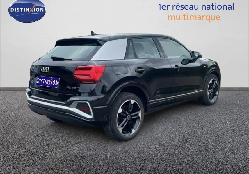 Audi Q2 noir mito metal vue 3/4 arrière droit, jantes alliage noires et toit contrasté gris clair.