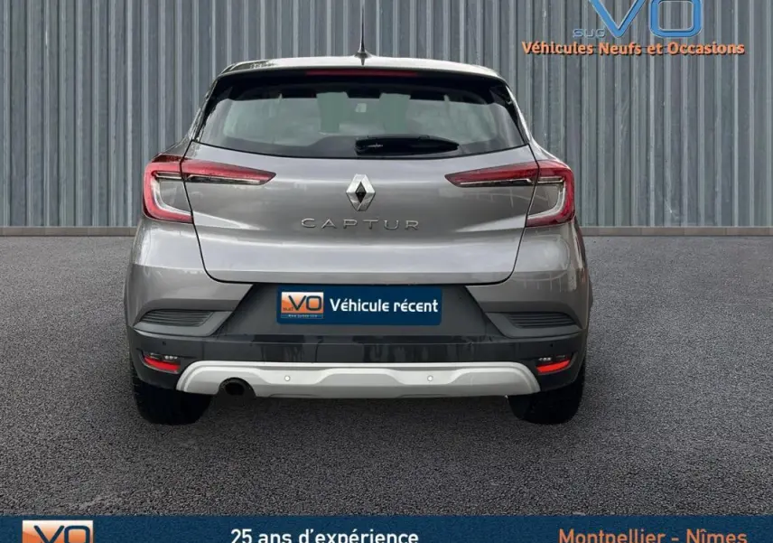Vue arrière d'un Renault Captur gris 2021 avec feux LED et badge Business visible sur un sol goudronné.