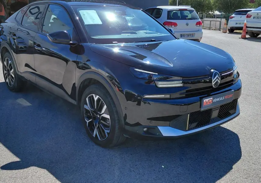Citroën C4 X hybride noir vue 3/4 avant droit, avec jantes alliage 17 pouces et toit ouvrant panoramique.
